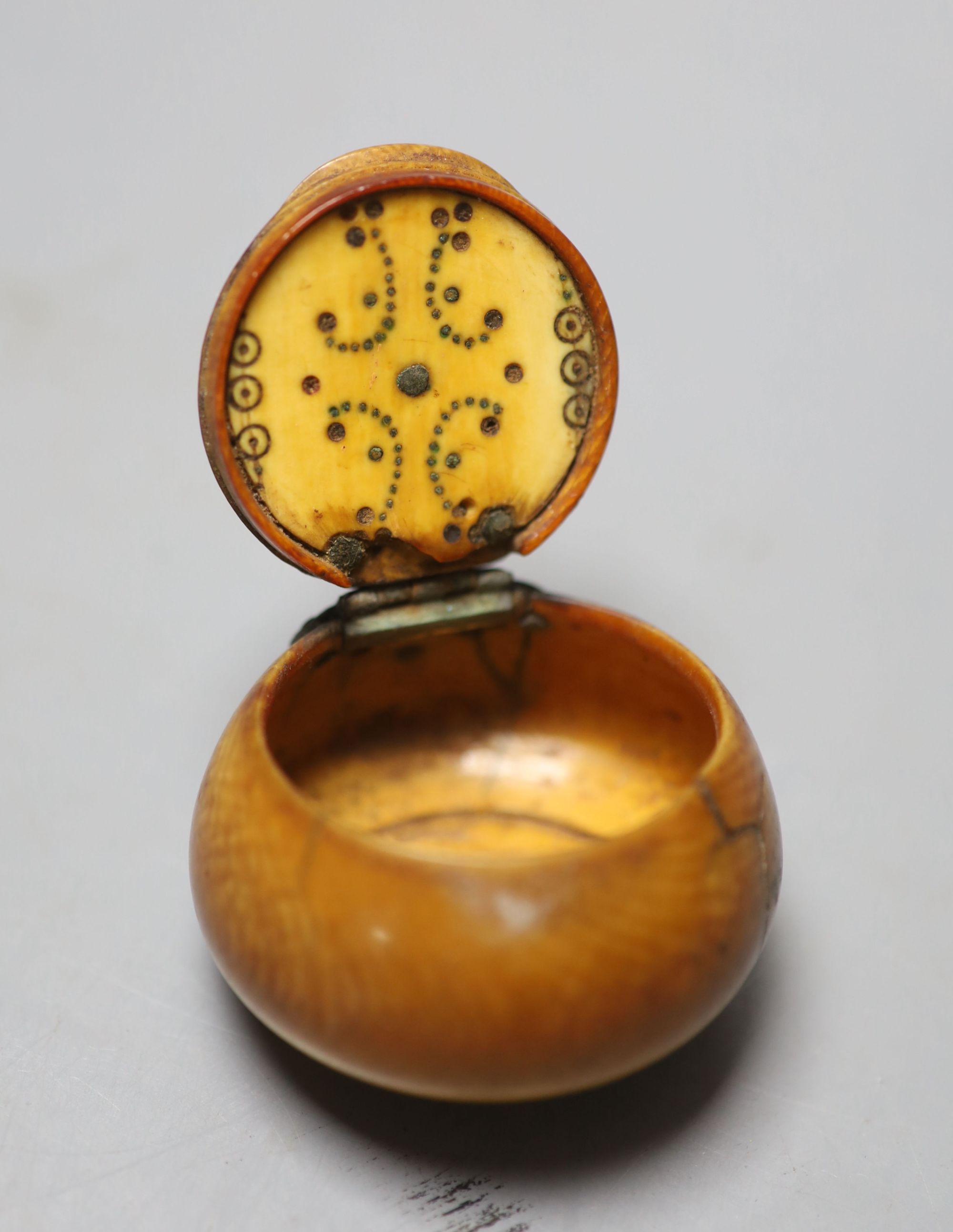 A 17th century French white metal mounted ivory snuff box, with pique work to inner lid, diameter 4.5cm